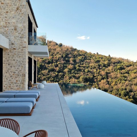 Enjoy the infinity lap pool, which seems to float above the treetops