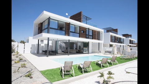 Stretch out beside the private pool under clear blue skies