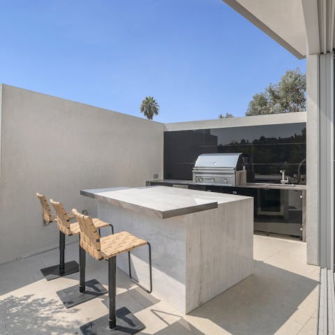 Get the grill going in the outdoor kitchen and bar
