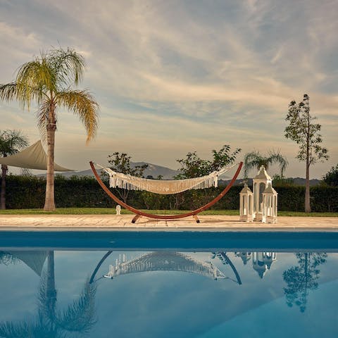 Soak up your paradisiacal surroundings from the swinging hammock