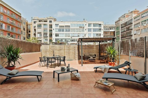 Stretch out on the shared terrace as Barcelona hums around you