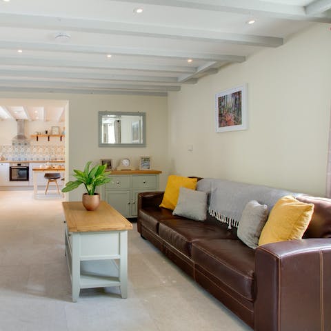 Relax on the plush sofa, cosy with the throws and pillows, watching a film on the smart TV