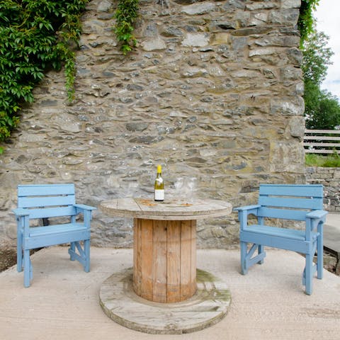 Sip on sundowners around the rustic outdoor table, surrounded by idyllic scenery