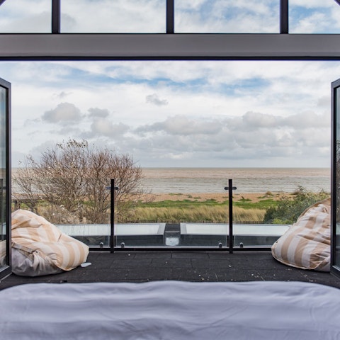 Wake up to the panoramic views of the sea from the luxurious master bedroom
