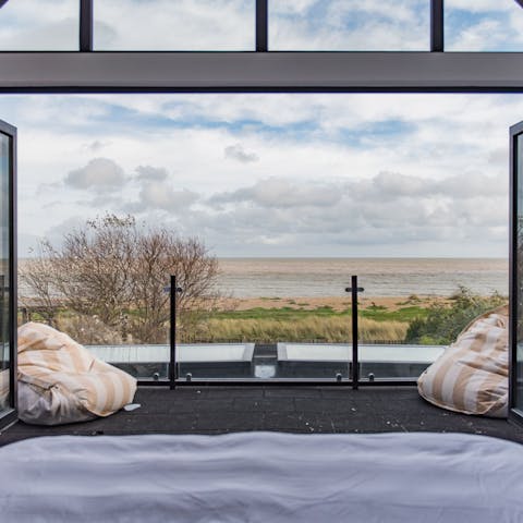 Wake up to the panoramic views of the sea from the luxurious master bedroom