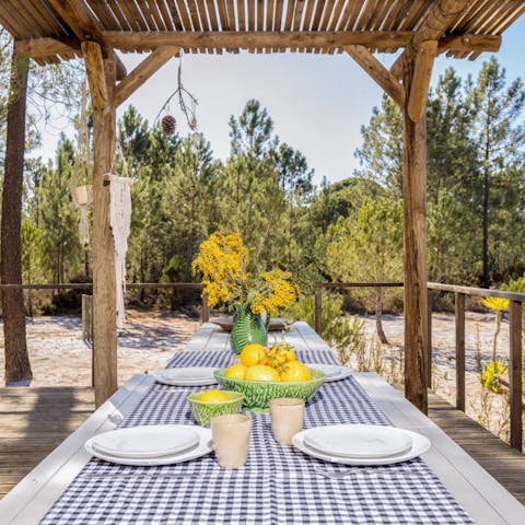 Gather around the dining table on the covered terrace for evening drinks