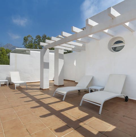 Catch some rays on the terrace's loungers while you sip a cocktail