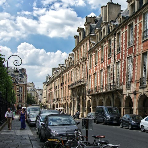 Stroll around elegant Place des Vosges, ten minutes away on foot