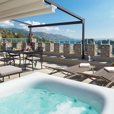 Soak in the hot tub with a glass of champagne in hand