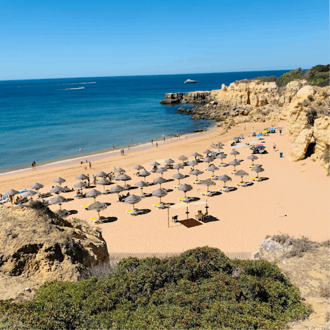 Spend leisurely days soaking up the sun on Vilamoura Beach, a 4-km walk away