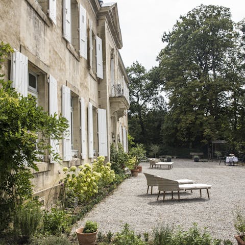 Wander the lush grounds, stopping to rest on the terrace's chaise lounges