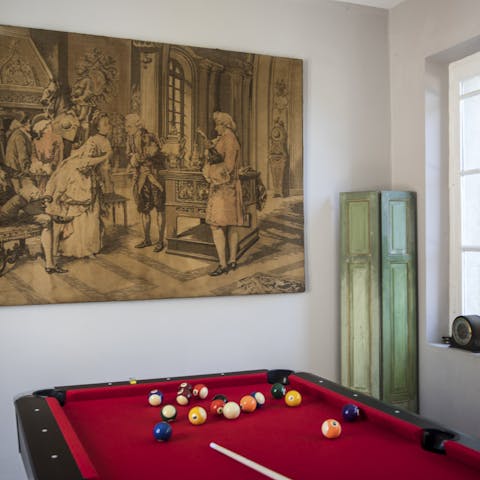 Play a competitive game of pool under the watchful eye of period decor