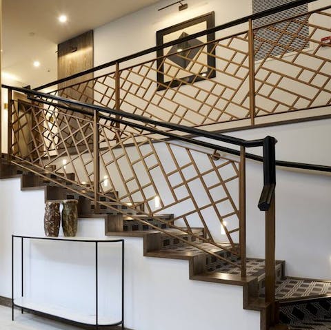 Descend the building's grand staircase on your way out to dinner