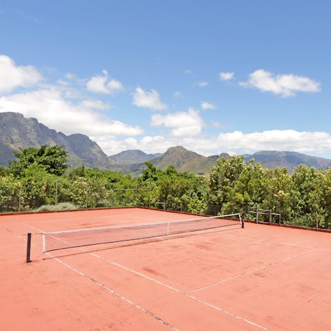 Play tennis against the mountain view backdrop