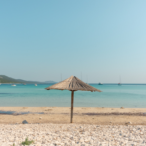 Paddle in the shallows of Playa de la Chapas – it's a short drive away