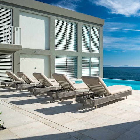 Soak up the Madeira sunshine from the poolside loungers with a cocktail in hand