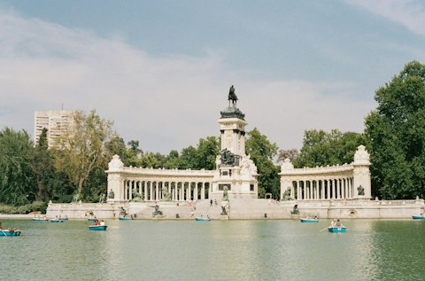 Enjoy a leisurely stroll around Retiro Park on a sunny afternoon