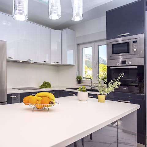 Rustle up a delicious lunch in the sleek, modern kitchen, to enjoy alfresco