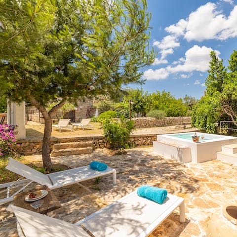 Enjoy sun-dappled relaxation by the private whirlpool