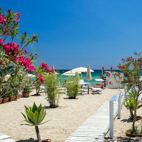 Stroll through the garden gate, directly onto a sandy beach