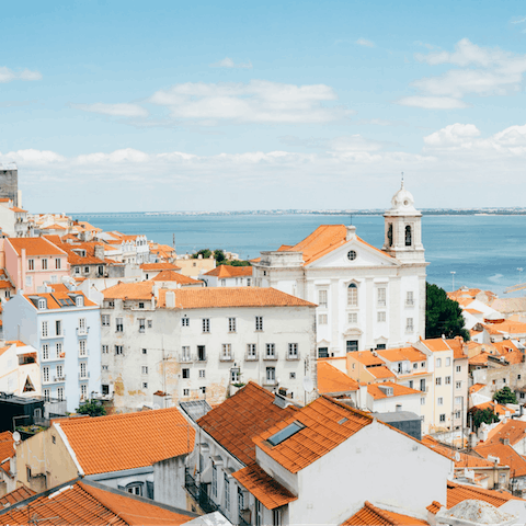 Sip a glass of vinho verde at the Miradouro da Graça viewpoint, a seven-minute walk from your apartment
