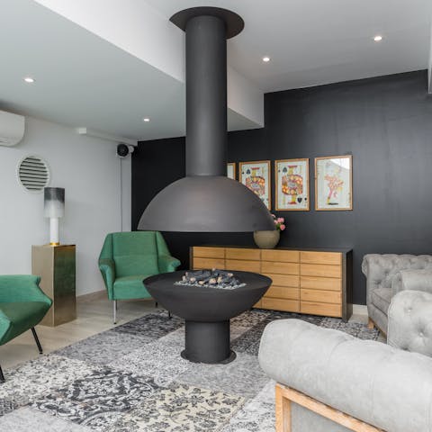 Cosy up with a glass of wine by the indoor fire pit in the shared lounge