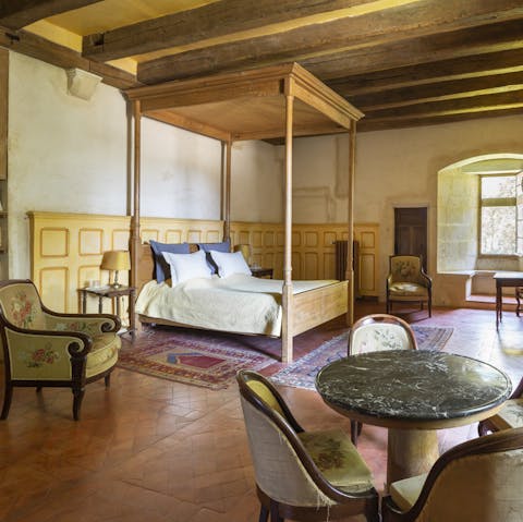 Sink into the luxurious four-poster beds