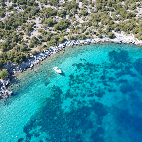 Take a boat trip around the island and swim in turquoise waters