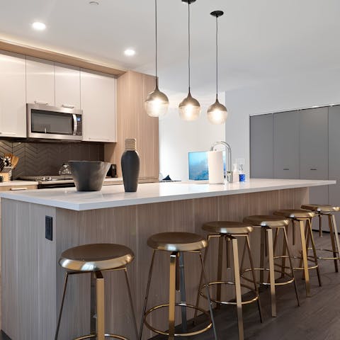 Whip up delicious meals in the sleek kitchen with breakfast bar