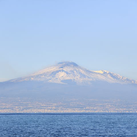 Admire the spectacular view of Mt Etna on the horizon