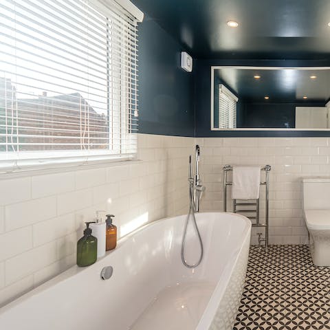 Lie back in the sleek bathtub and feel your worries float away
