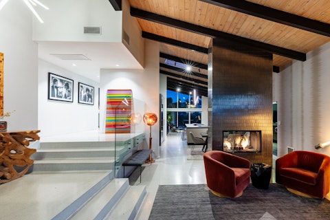 Gather around the fireplace as evening light fades outside
