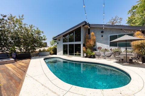 Spend your days poolside, cold drink and book in hand
