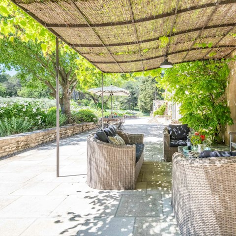 Gather for drinks in the garden surrounded by lush greenery