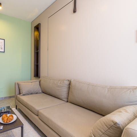 Stretch out, relax, and watch the smart TV on the plush sofa after a long day out in the city