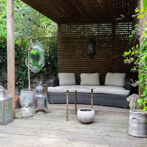 Light the lanterns and enjoy cocktails into the night in the covered seating area