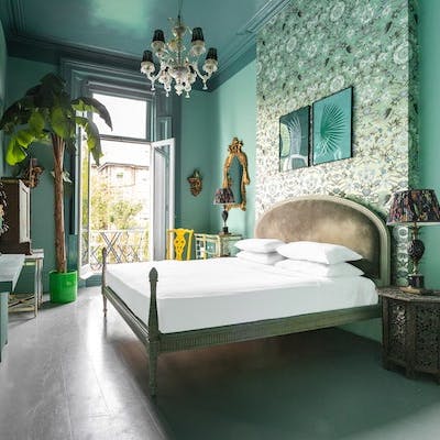 Get some rest in the main bedroom with its faux palm tree