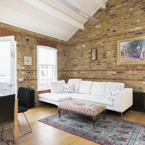 Relax in the airy living room that was once a carpentry shop