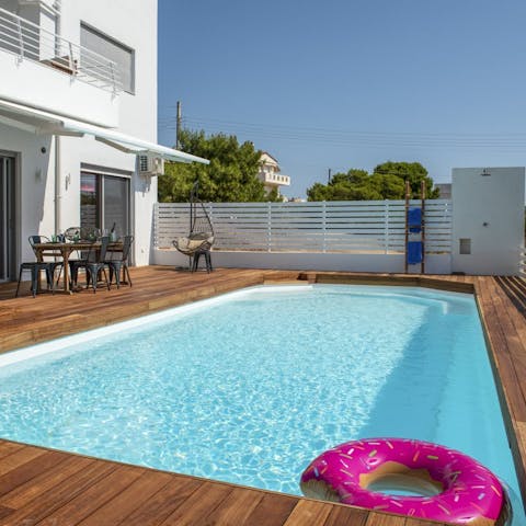Relax with a chilled drink beside the private pool