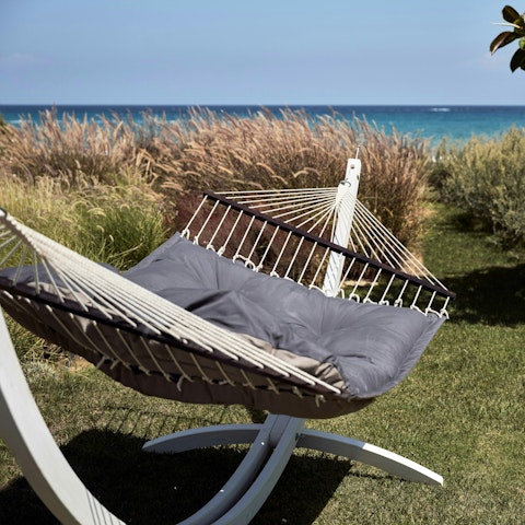 Bask in a gentle sea breeze as you relax in the hammock