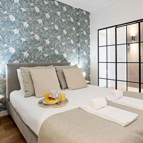 Get some rest in the bedroom with its pretty floral wallpaper