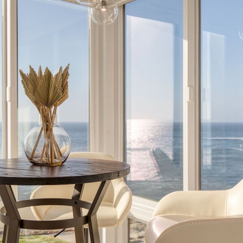Gather around the breakfast table as panoramic ocean views fill every window