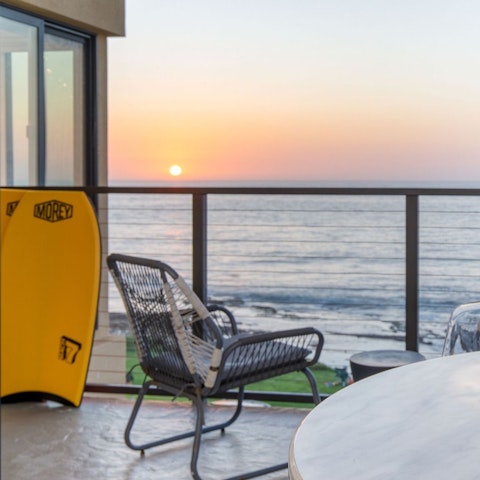 Watch the sun sink into the Pacific from your private balcony