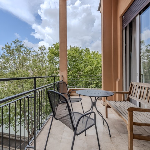 Catch a glimpse of the Tiber on the private balcony