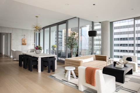 Spread out across a light-filled living and dining area with city views