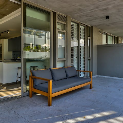 Kick back on the outdoor sofa, enjoying a nice glass of South African wine and reading a good book