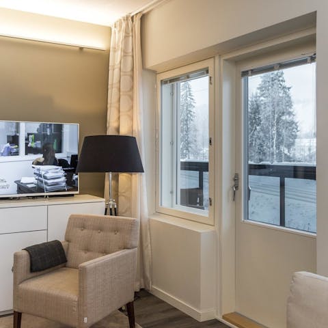 Cosy up on the armchair while you gaze outside at the snowy landscape