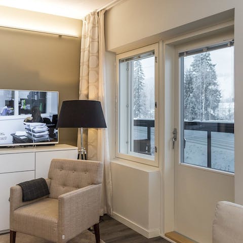 Cosy up on the armchair while you gaze outside at the snowy landscape