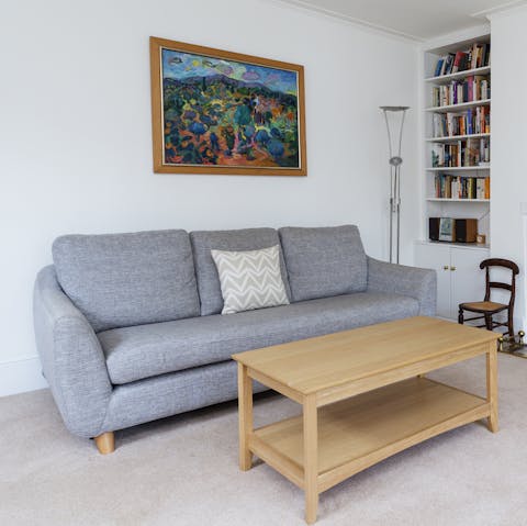 Curl up on the sofa with a book from the bookshelves