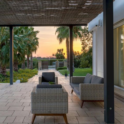 Gather on the outdoor sofas for wine and snacks as the sun sets